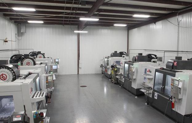 Rows of large CNC machines in a large room