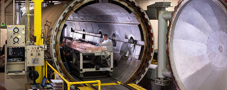 Man working inside large autoclave